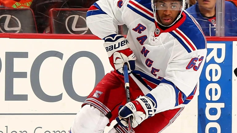 Anthony Duclair of the Rangers takes the puck in the...
