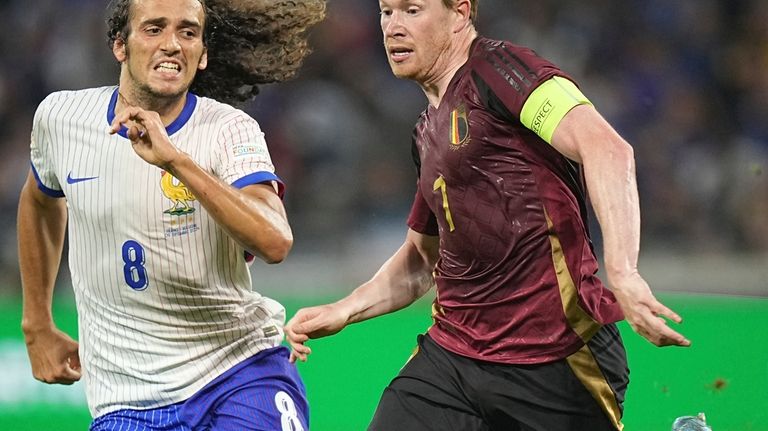 France's Matteo Guendouzi, left, tries to stop Belgium's Kevin De...