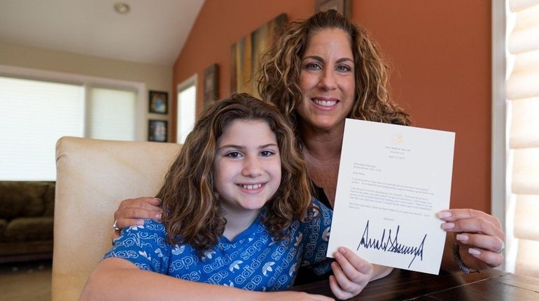 Sixth-grader Bella Moscato, 11, and her mother, Valerie, hold a...