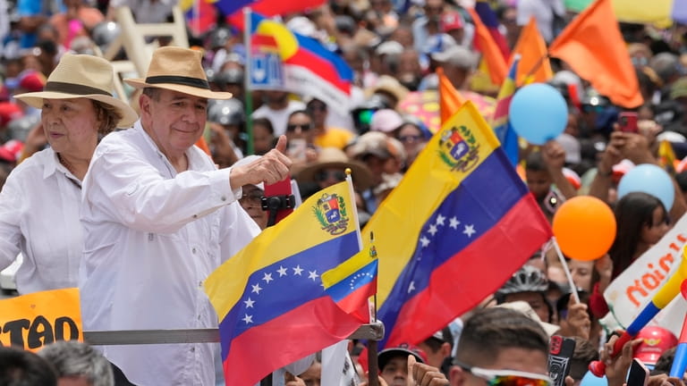 Venezuelan opposition presidential candidate Edmundo Gonzalez, accompanied by wife Mercedes,...