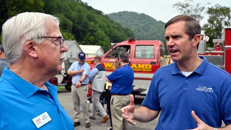 Kentucky Gov. Andy Beshear, right, speaks with John Pearce with...