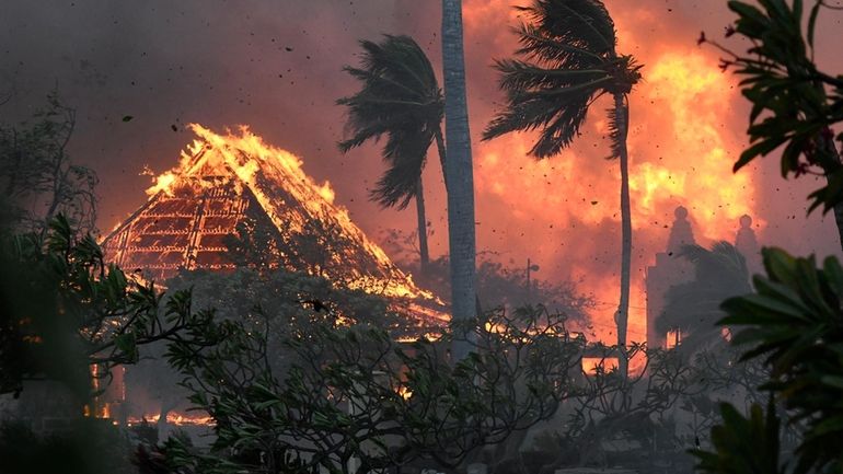 Waiola Church and nearby Lahaina Hongwanji Mission are engulfed in...