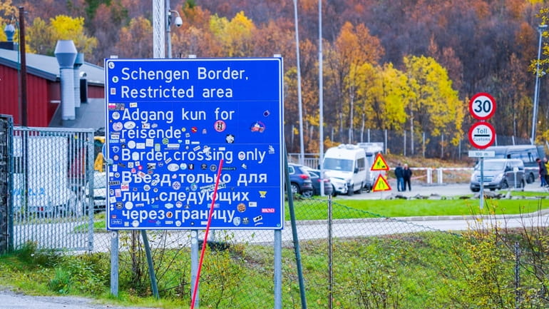 A sign indicating the Storskog border crossing between Russia and...