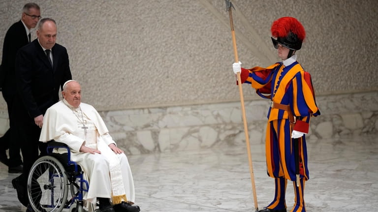 Pope Francis arrives on a wheelchair at his weekly general...