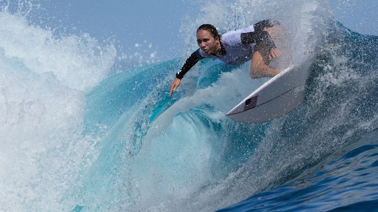 Carissa Moore, of the United States, surfs on a training...