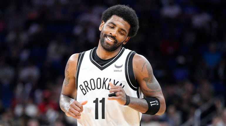 Kyrie Irving #11 of the Nets reacts after scoring against...