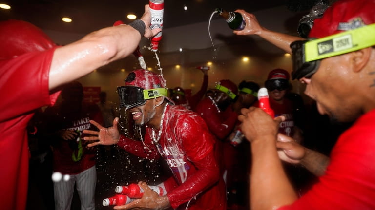 Philadelphia Phillies' Johan Rojas celebrates after winning a baseball game...
