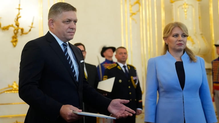 Slovakia's President Zuzana Caputova, right, and newly appointed Prime Minister...