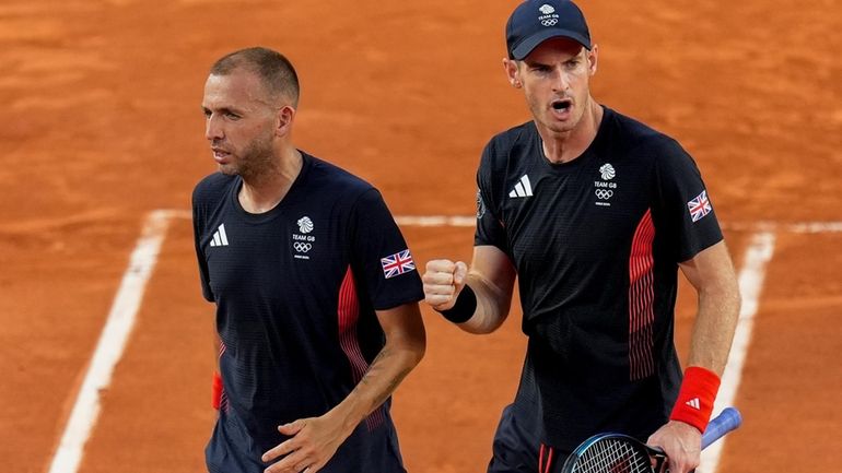 Andy Murray, right, and Daniel Evans of Britain celebrate a...