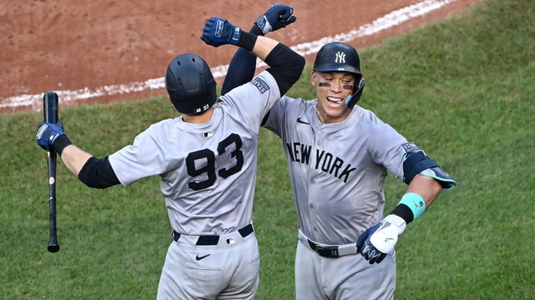 The Yankees' Aaron Judge, right, celebrates after his solo home...