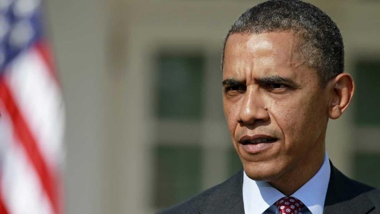 President Barack Obama answers a reporter's question in the Rose...