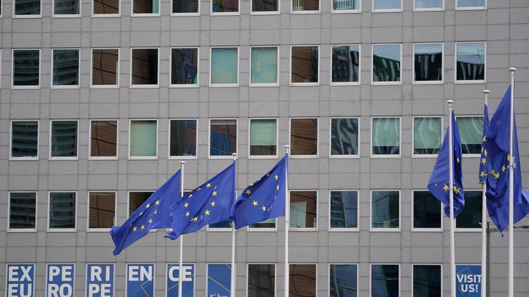 European Union flags flap in the wind in the EU...