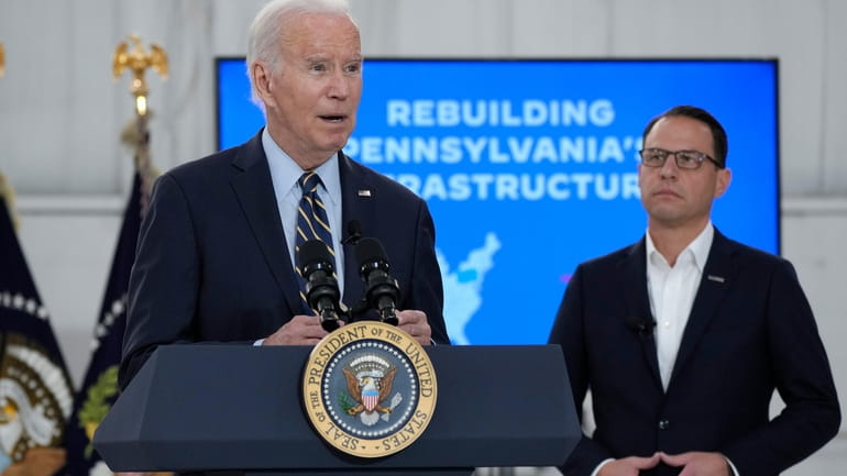 Pennsylvania Gov. Josh Shapiro, right, listens as President Joe Biden...