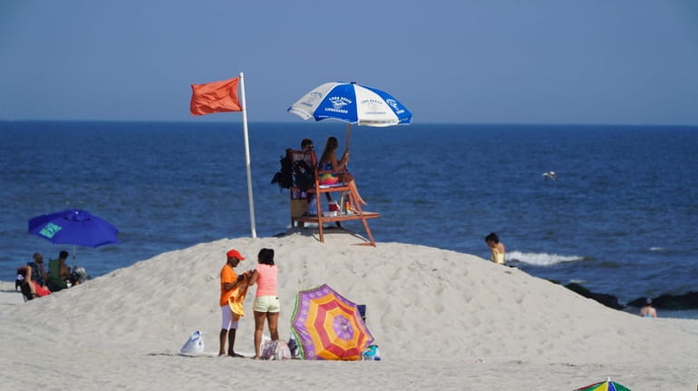 Long Beach lifeguards put out red flags after sharks were...
