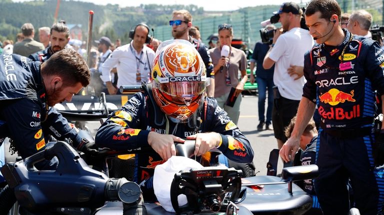 Crew prepare the car of Red Bull driver Max Verstappen...