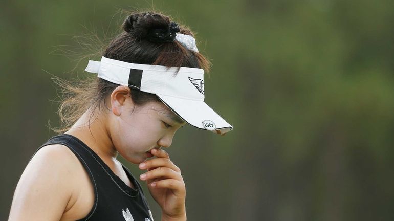 Lucy Li, 11, of the United States walks off the...