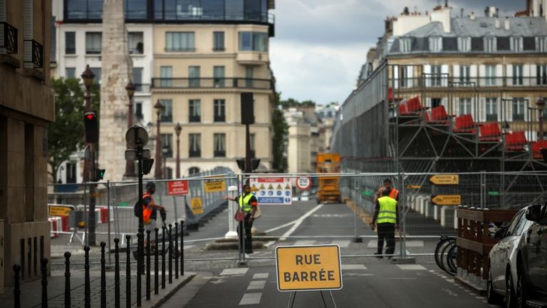 Security officers stand at the security perimeter of a closed...