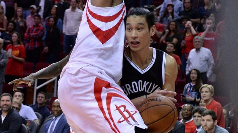 Brooklyn Nets guard Jeremy Lin drives against Houston Rockets center...