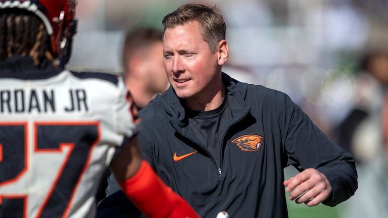 Newly appointed Oregon State head coach Trent Bray greets players...