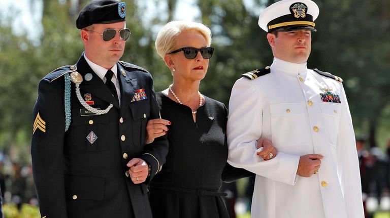 Cindy McCain, escorted by sons, Jack McCain, right, and Jimmy...