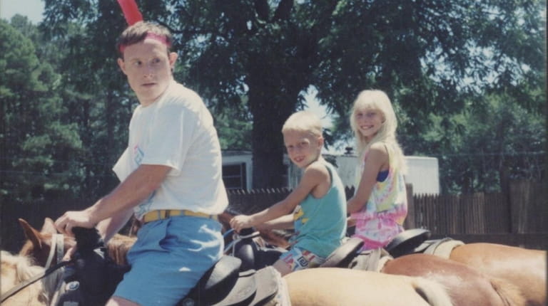 Michael Kaminski, left, rides horses with Robert and Kelly Zimmermann.