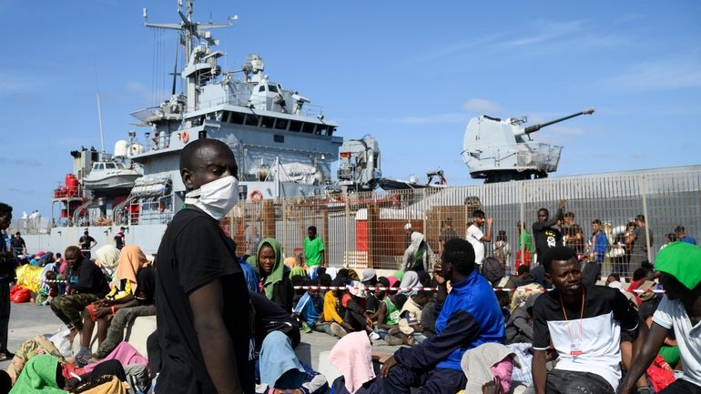 Migrants wait to be transferred from Lampedusa Island, Italy, Friday,...