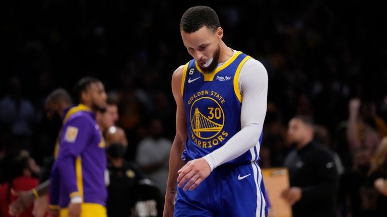 Golden State Warriors guard Stephen Curry walks on the court...