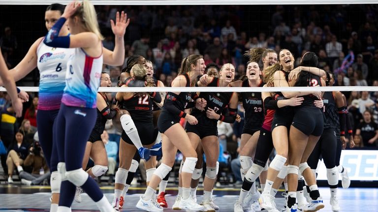 Atlanta Vibe, right, celebrate their five-set victory over the Omaha...