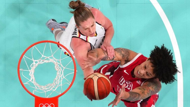 United States' Brittney Griner, right, and Belgium's Emma Meesseman reach...