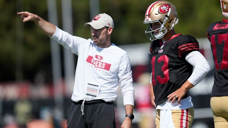 San Francisco 49ers offensive passing game specialist Klay Kubiak, left,...