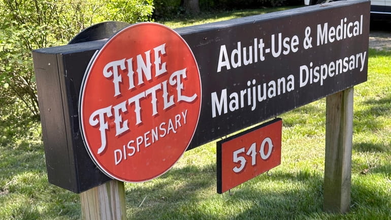 A sign advertises the Fine Fettle cannabis dispensary on June...