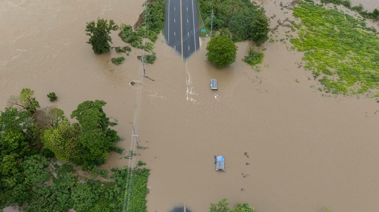 La Plata river floods a road after Tropical Storm Ernesto...