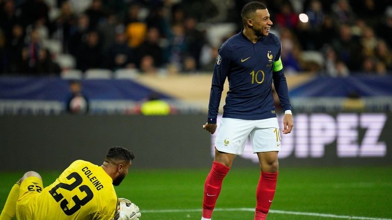 France's Kylian Mbappe smiles as Gibraltar goalkeeper Dayle Coleing makes...