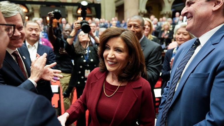 New York Gov. Kathy Hochul greets people as she arrives...