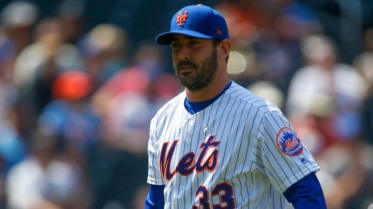 Matt Harvey of the Mets walks to the dugout after...