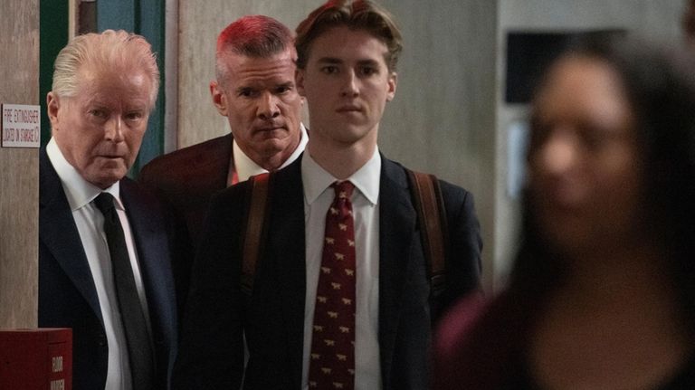 Musician Don Henley, left, surrounded by security, arrives at Supreme...