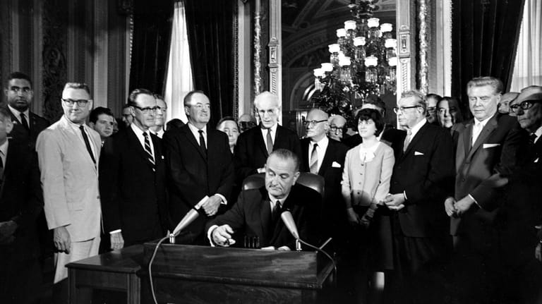 In this Aug. 6, 1965, photo, President Lyndon B. Johnson...