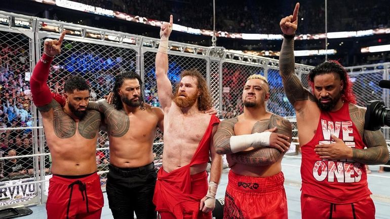 (L-R) WWE wrestlers Jey Uso, Roman Reigns, Sami Zayn, Solo...