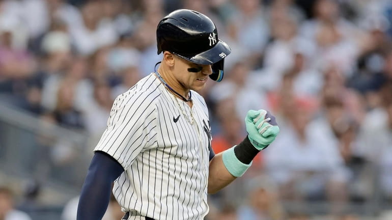 Aaron Judge #99 of the Yankees reacts after he was...