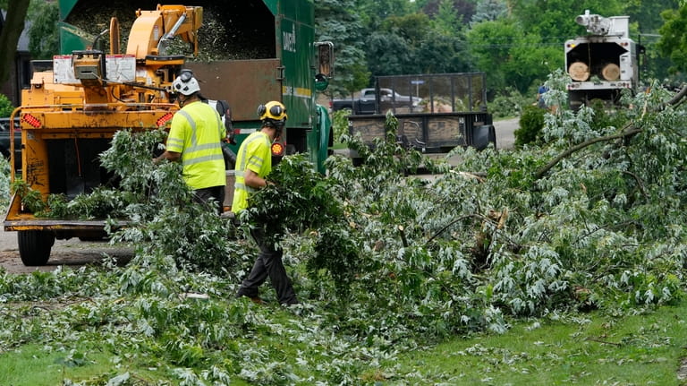 Work crews clean up Friday, June 21, 2024 in Beverly...