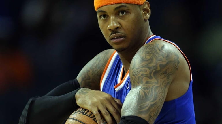 Carmelo Anthony holds the ball before a game against the...