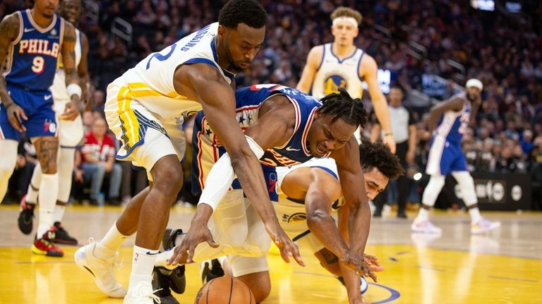 Philadelphia 76ers forward Danuel House Jr., center, battles Golden State...