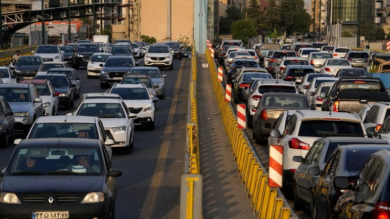 People commute in their cars during an afternoon traffic jam...