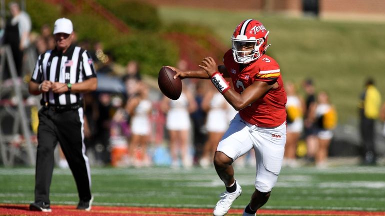 Maryland quarterback Taulia Tagovailoa scambles against Towson in the first...