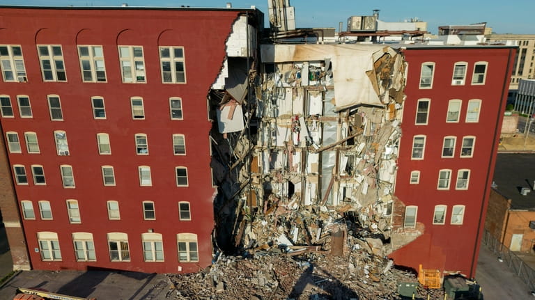 An apartment building that partially collapsed two days earlier can...