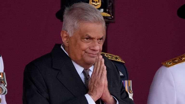 Sri Lankan President Ranil Wickremesinghe greets a group of school...