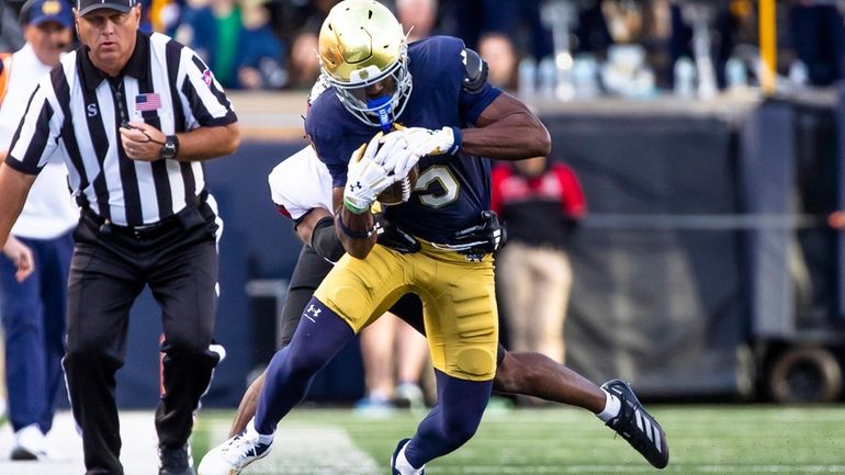 Notre Dame wide receiver Beaux Collins (5) tries to run...