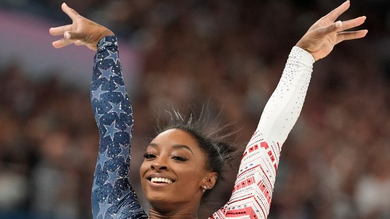 Simone Biles, of the United States, performs on the balance...