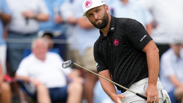 Jon Rahm, of Spain, reacts after missing a putt on...