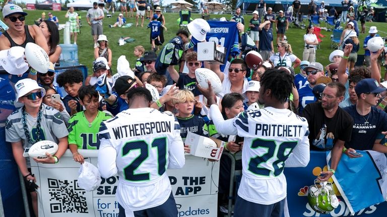 Seattle Seahawks cornerback Devon Witherspoon (21) and cornerback Nehemiah Pritchett...